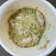 Chicken bathing in marinade in bowl